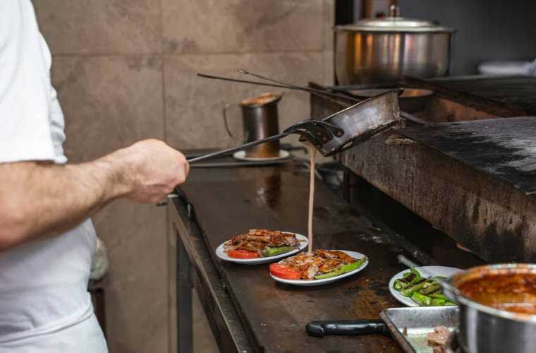human preparing meat dish