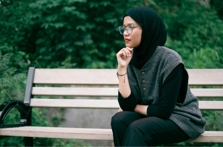 human sitting on bench